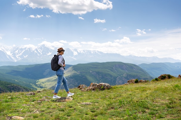 Woman with backpack hiking Lifestyle adventure concept.