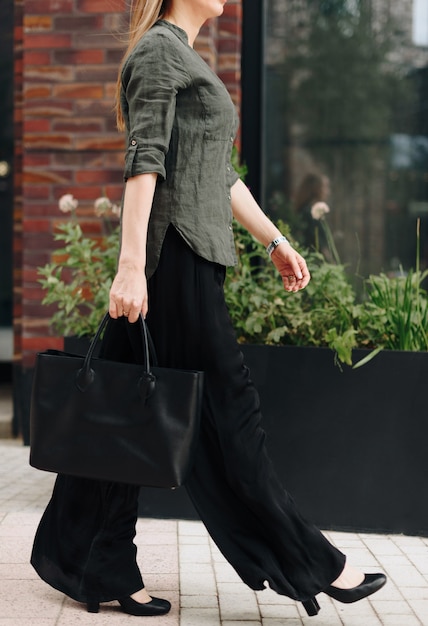 A woman with a bag on the background of the city