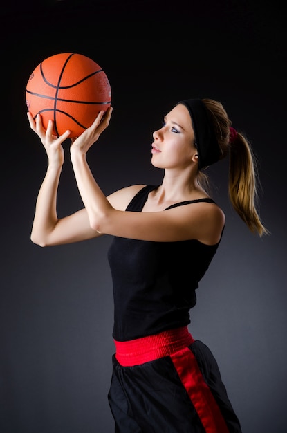 Woman with basketball in sport concept