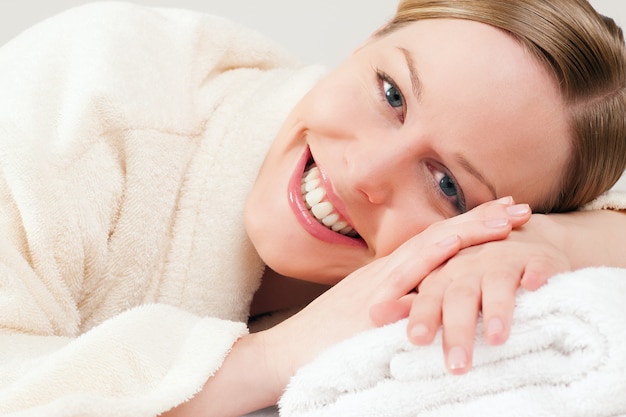 Woman with bath robe in spa