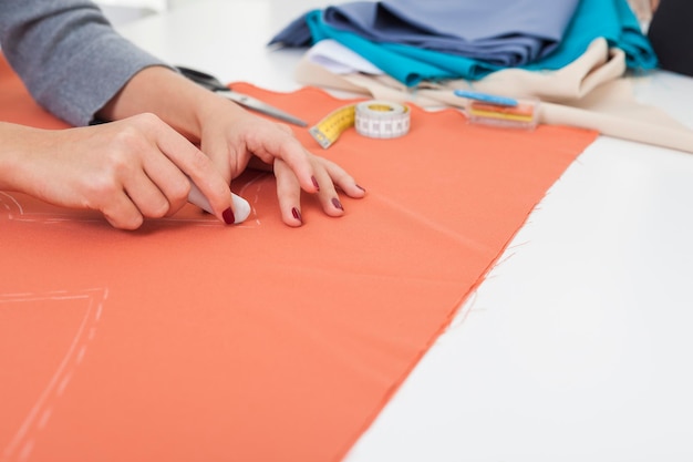 Woman with beautiful hands is drawing a pattern