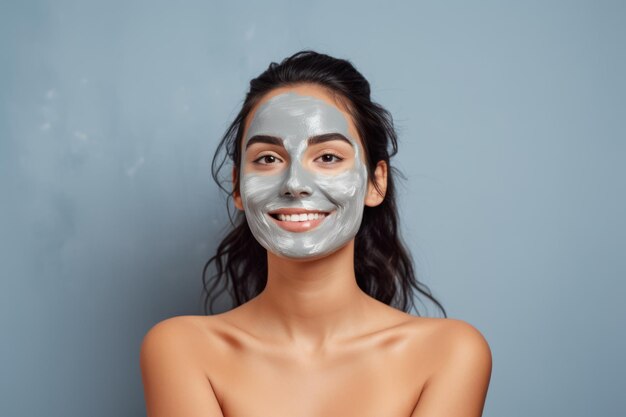 Woman with beauty face mask on solid background