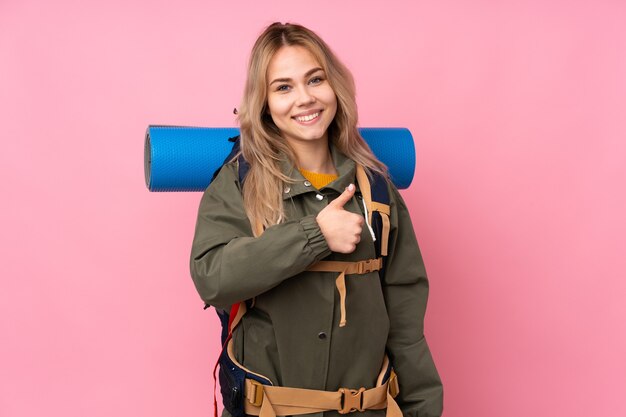 Woman with a big backpack in studio