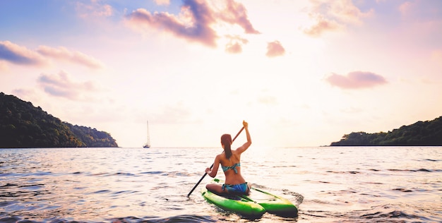 Woman with bikini on paddle board