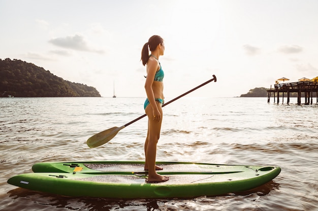 Woman with bikini on paddle board