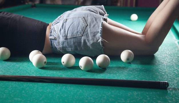 Woman with a billiard balls on the table.