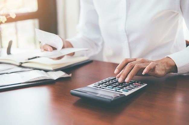 Woman with bills and calculator. 