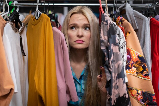 A woman with blonde hair disappointed with shopping at the mall