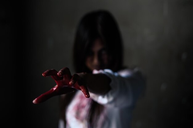 Photo woman with bloody hand in darkroom