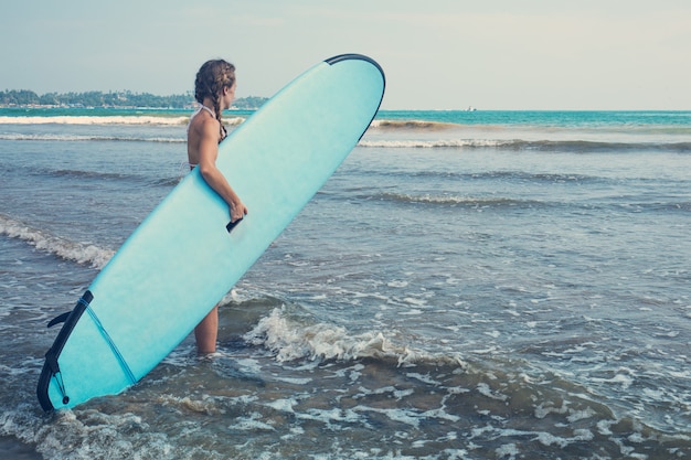 Woman with board for surfing