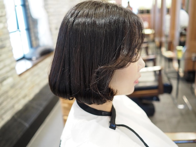 A woman with a bob cut is sitting in a salon.