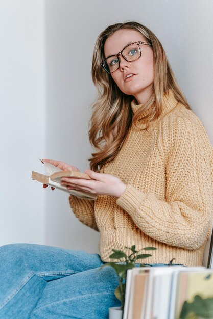 woman with book looking away photo