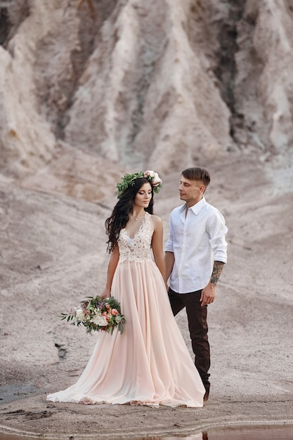 Woman with a bouquet of flowers in the arms of men