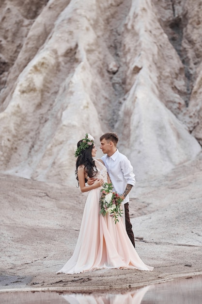 Woman with a bouquet of flowers in the arms of men. 