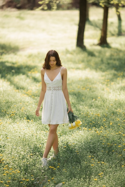 Woman with Bouquet of the Spring Flowers Outdoors