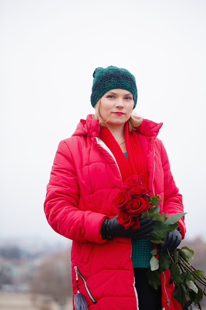 Woman with a bouquet walks down the street