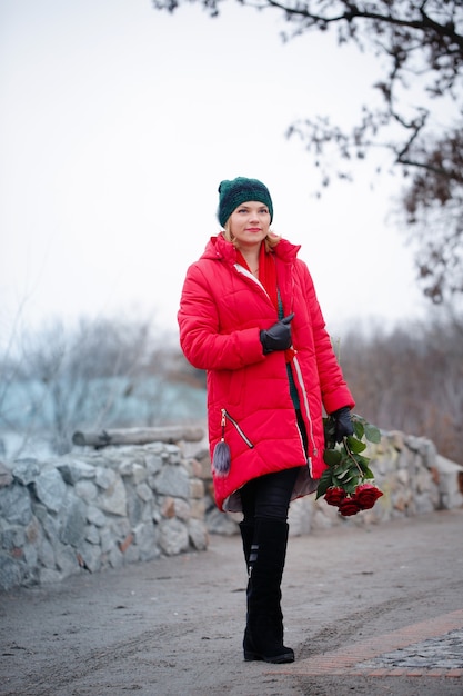 Woman with a bouquet walks down the street