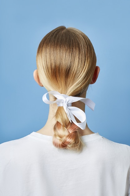 Woman with braided hair and bow