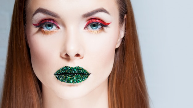 Woman with bright eye makeup and green lips