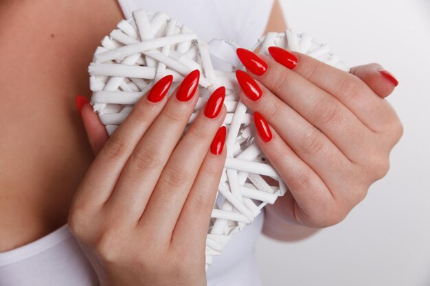 a woman with bright red nails and a white dress with a white dress that says " bright ".