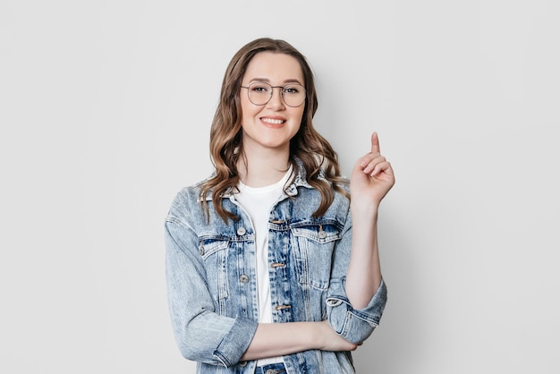 Woman with brown hair cross arms on chest looking at camera white background