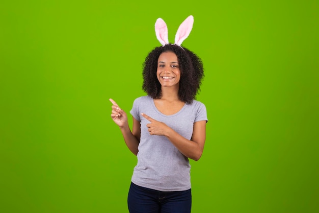 A woman with bunny ears on a green background