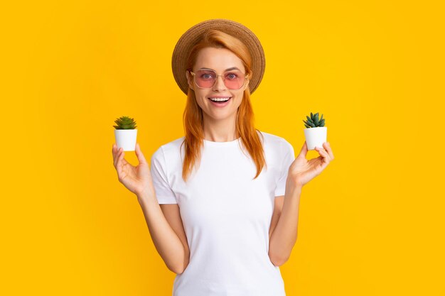 Woman with cactus in hands smiling woman and cactus