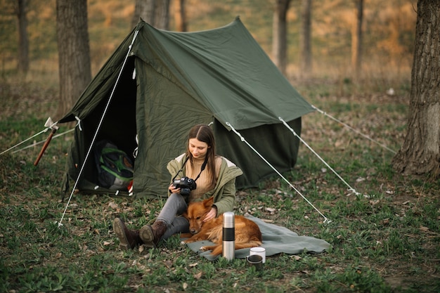 Photo woman with camera near tent