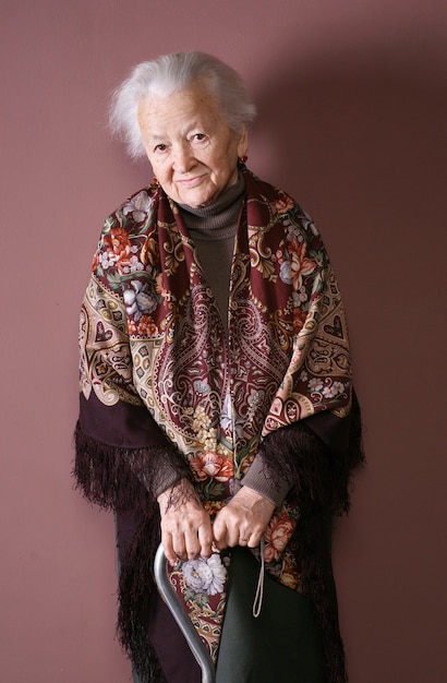 woman with a cane isolated on brown