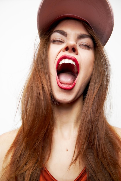 Photo woman with a cap model wide open mouth closed eyes on her head model