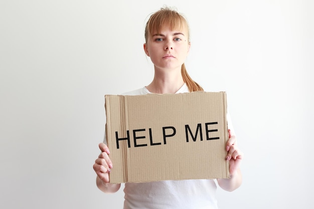 Woman with cardboard banner help me on white background social problems