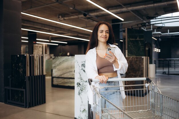 a woman with a cart in a hardware store