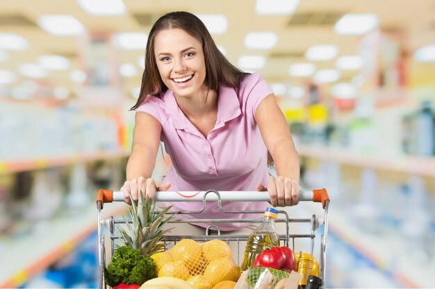 Woman with cart shopping in supermarket