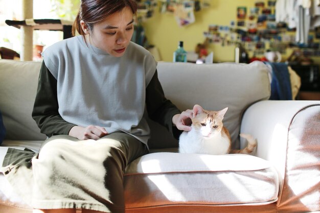 Foto donna con il gatto seduta sul divano