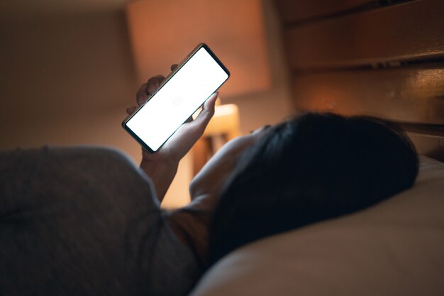 Woman with cellphone at home