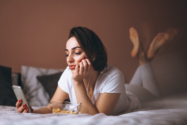 Woman with cereals and earphones