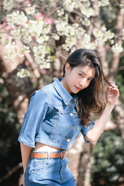 Woman with cherry blossoms or sakura flower blooming in the park