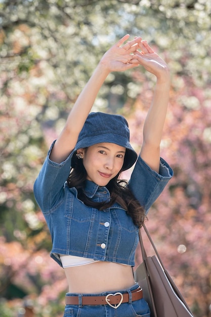 Woman with cherry blossoms or sakura flower blooming in the park