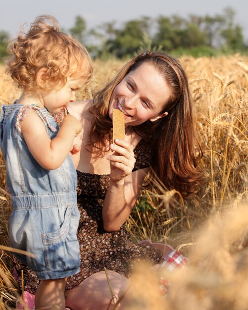 Woman with child in field of wheat