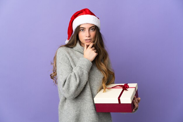 woman with christmas hat holding presents