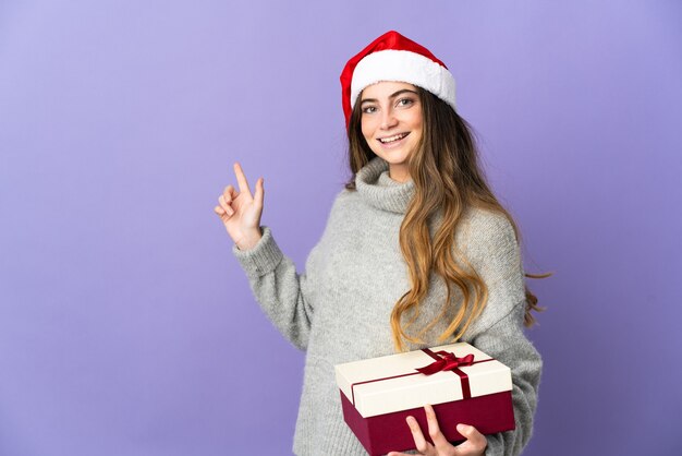 woman with christmas hat holding presents