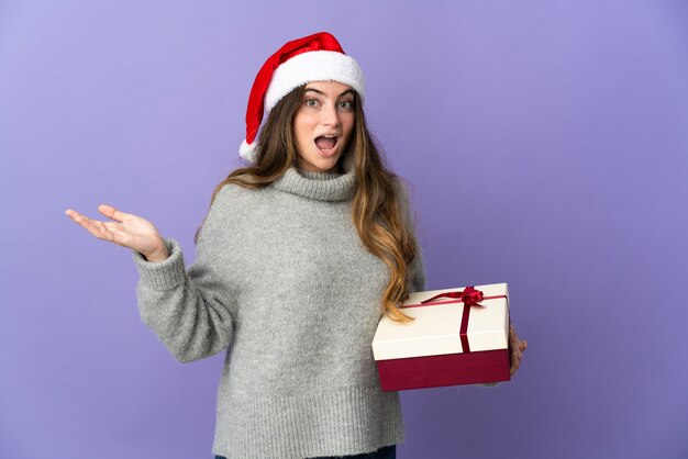 woman with christmas hat holding presents