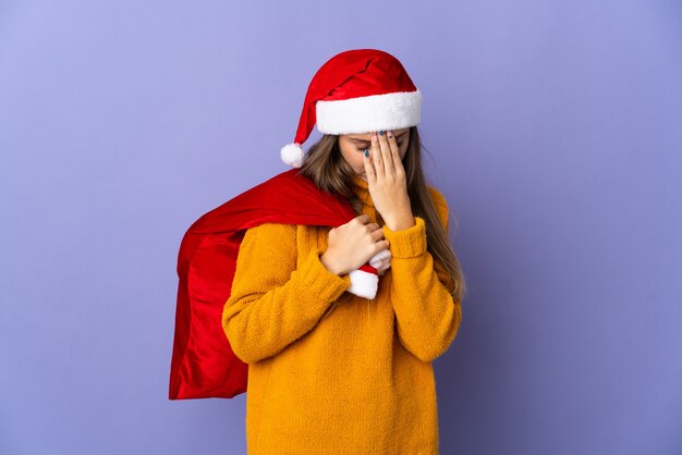 woman with christmas hat and santa bag