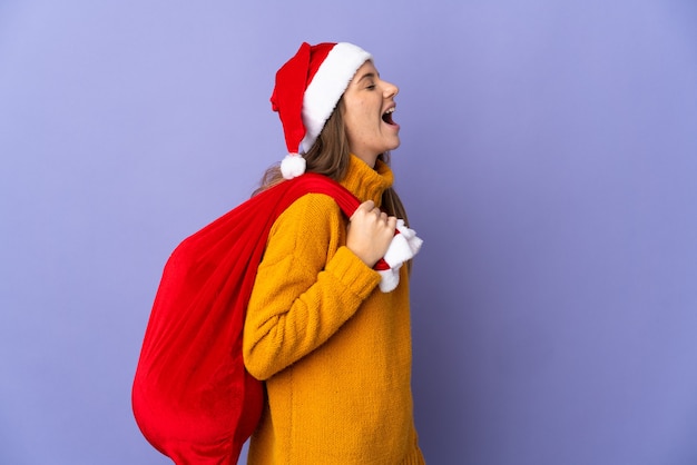 woman with christmas hat and santa bag