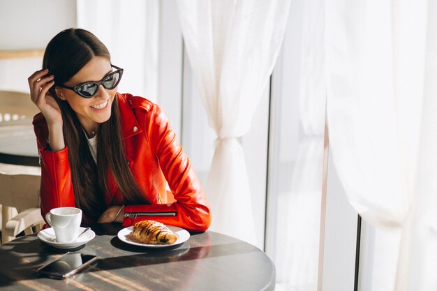 Woman with coffee and croissant