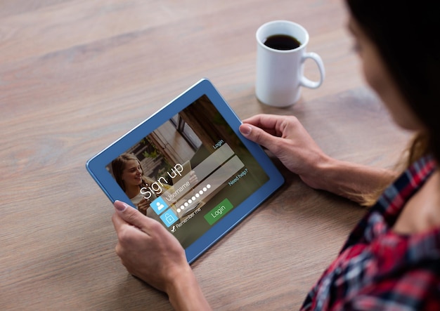 Woman with coffee and tablet in login screen