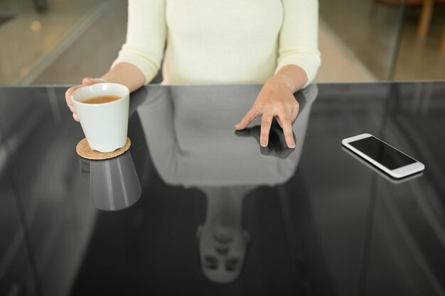 woman with coffee using black interactive panel