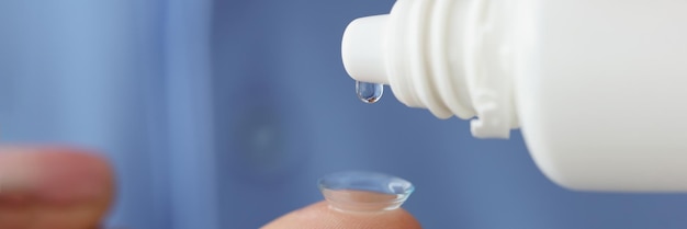 Woman with contact lenses drips moisturizing solution storage and care of eye lenses concept