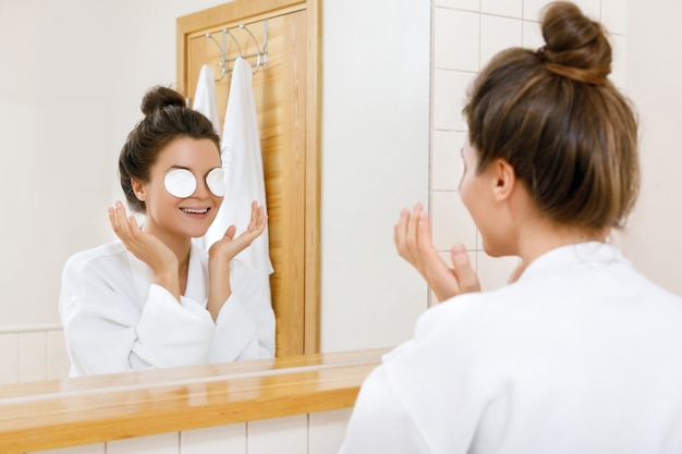 Woman with a cotton pads on her eyes