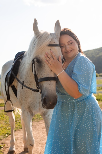 The woman with curly hair huddles to her horse